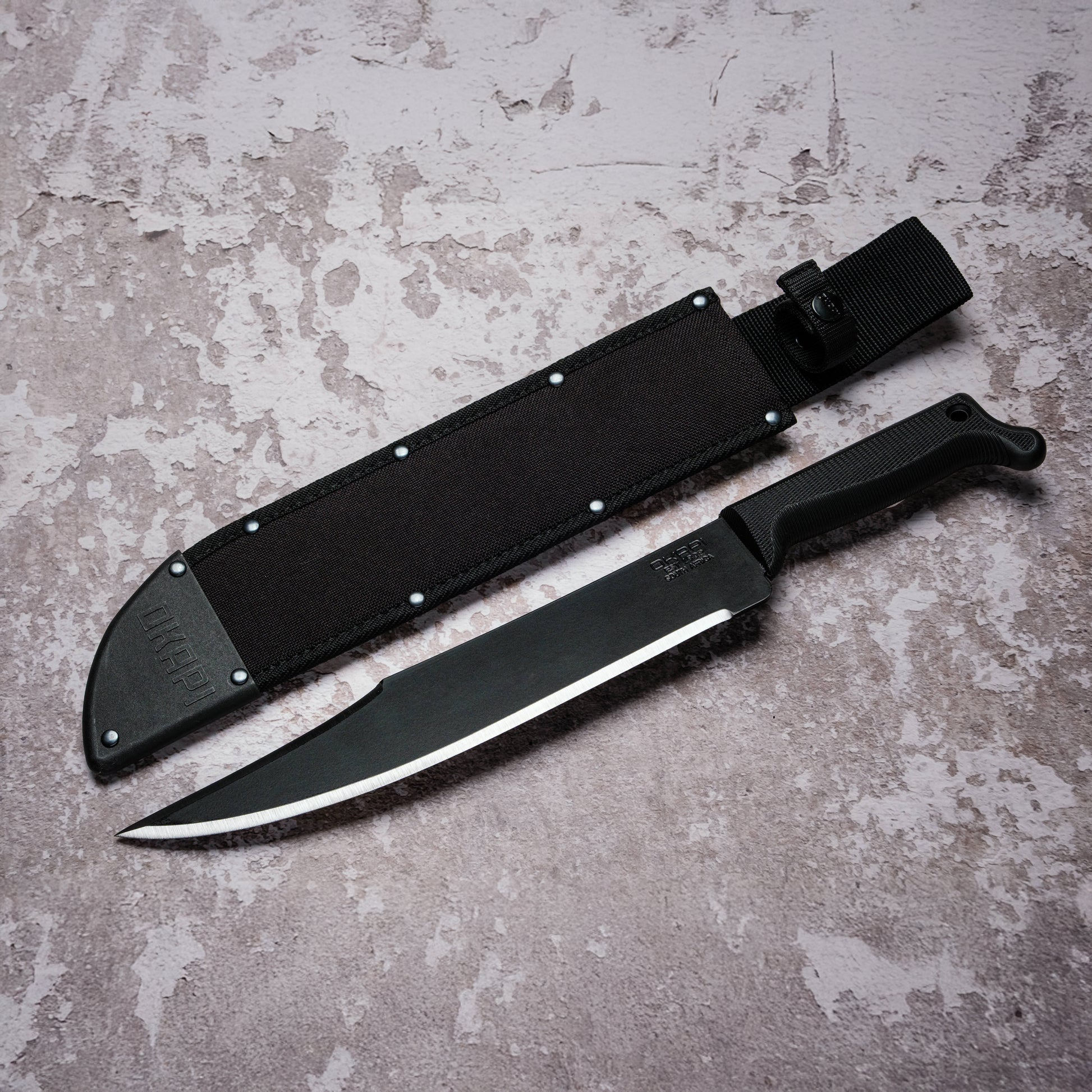 Okapi Bowie Machete with black handle with black Sheath on grey background