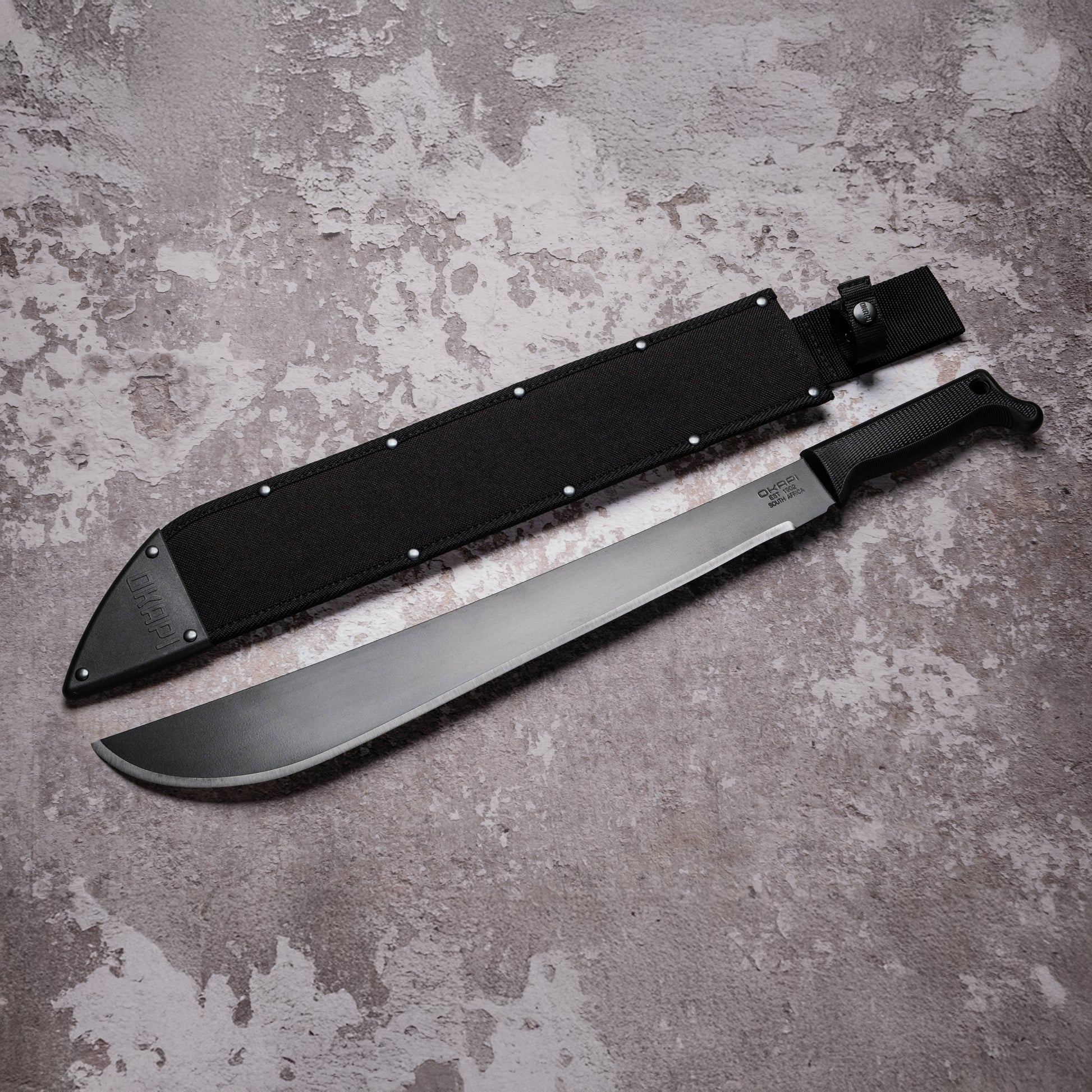 Okapi Latin Machete with black Sheath cover on grey background