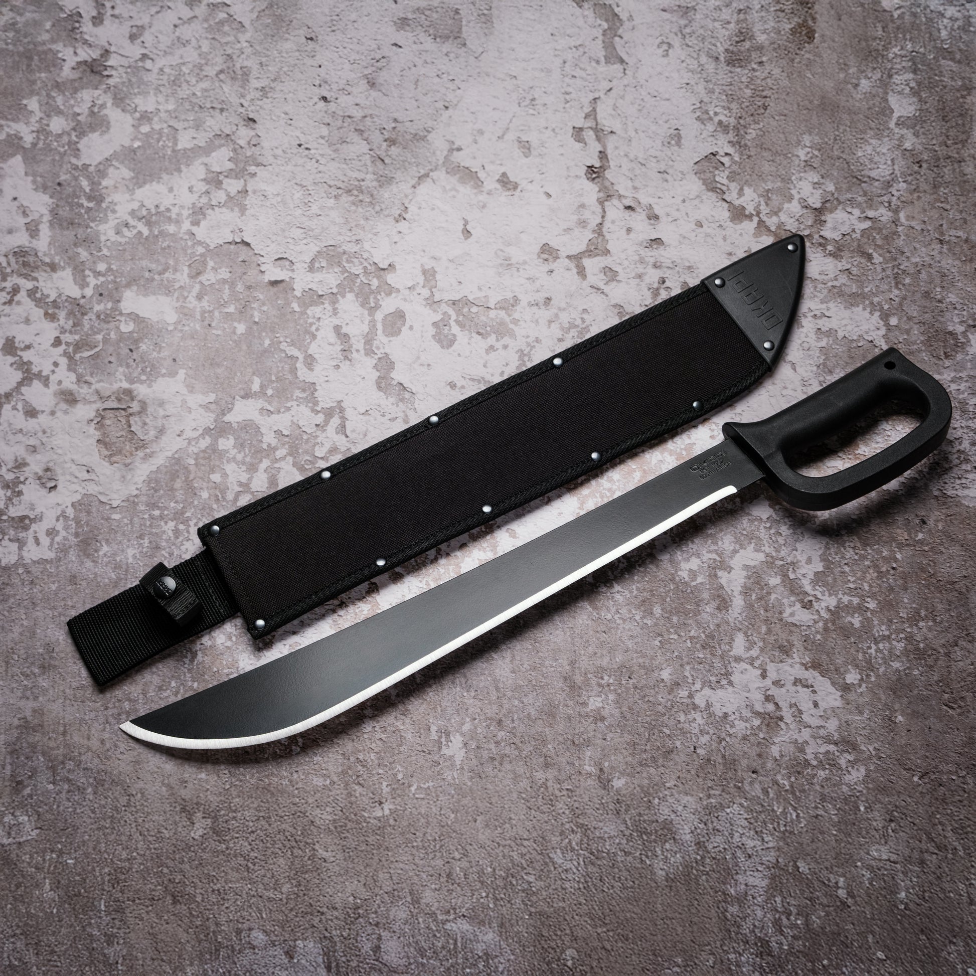 Okapi D-Ring Machete with black handle with black Sheath on grey background