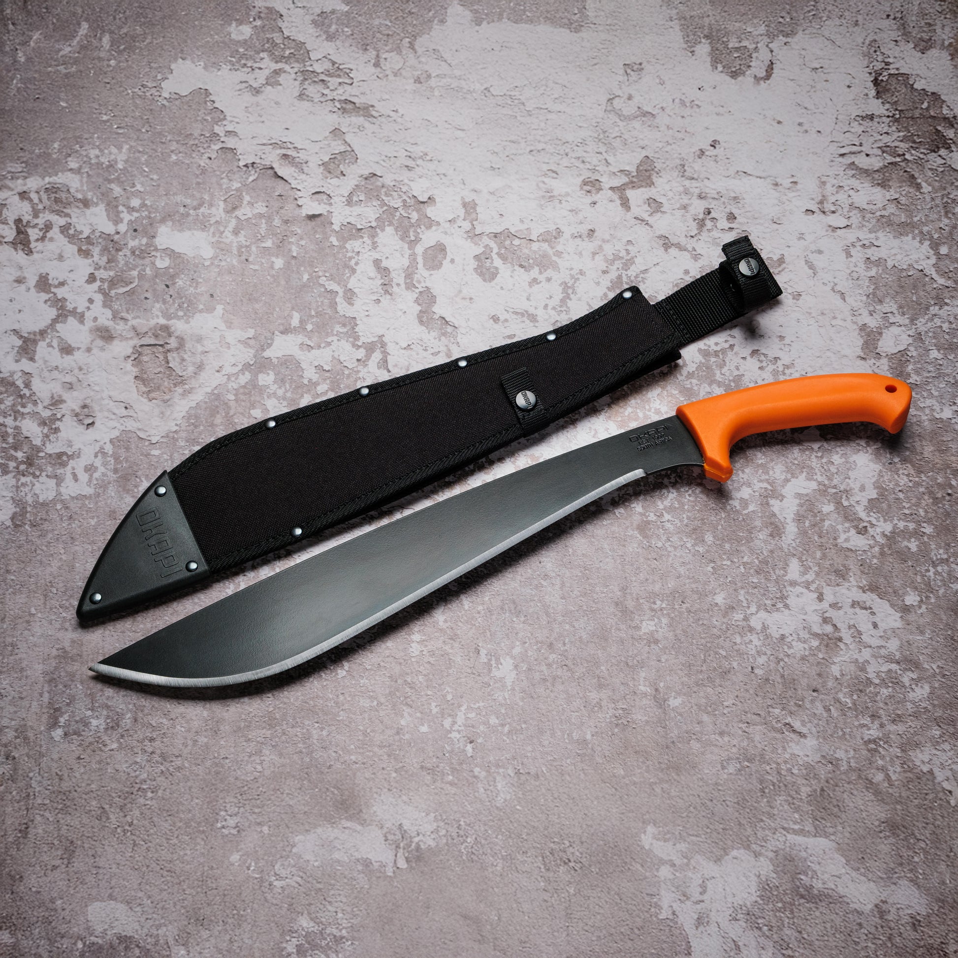 Okapi Jungle Machete with Okapi orange handle with black Sheath on grey background