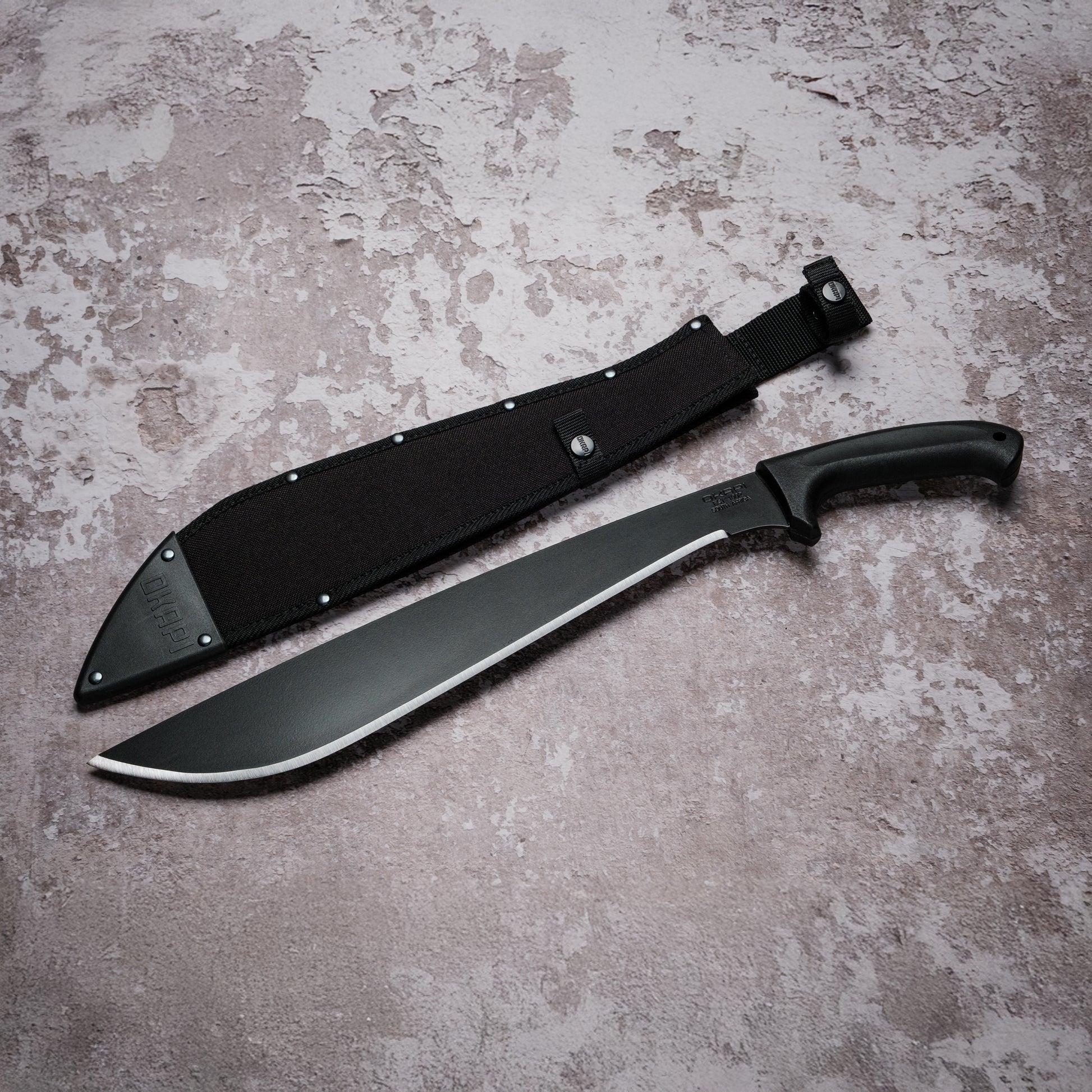 Okapi Jungle Machete with black handle with black Sheath on grey background