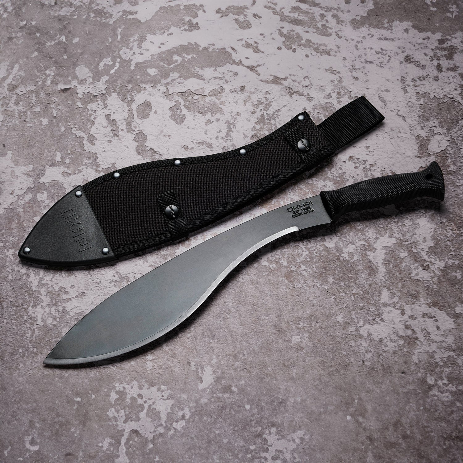Okapi Kukri Machete Sheath in black on concrete floor