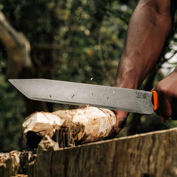 Outdoor lifestyle image of Okapi O-Tanto machete with bright orange tactical handle