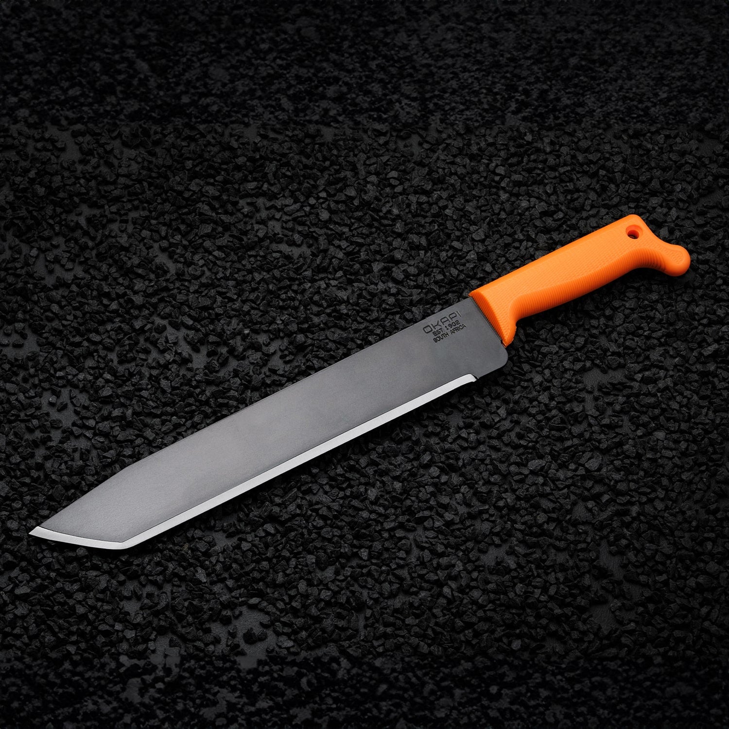 Okapi O-Tanto machete with straight-edged blade and orange grip shown on black stone background