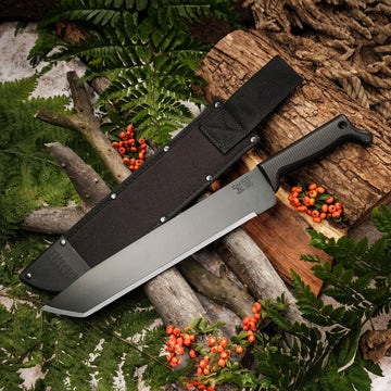 Tanto-style Okapi machete in sheath with black grip displayed on wooden background