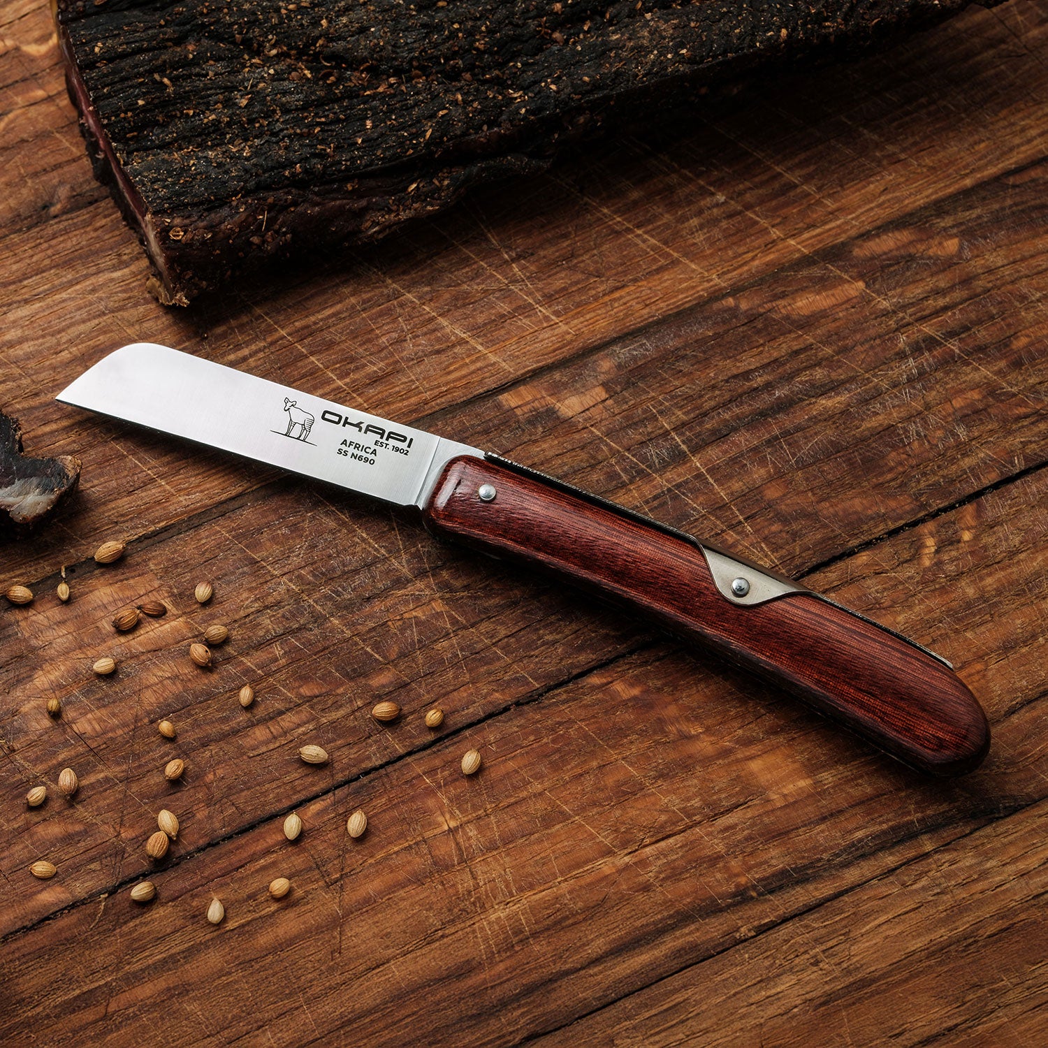 Okapi Biltong Knife with biltong in the background