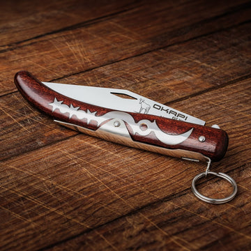 Closed Okapi Lock Knife with wooden handle on wooden background