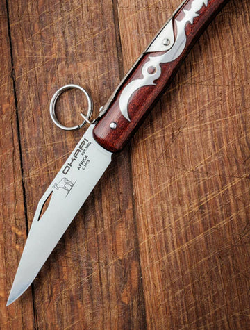 Okapi Lock 907E Knife on wooden background